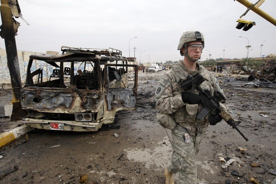 US soldier amidst bomb wreakage