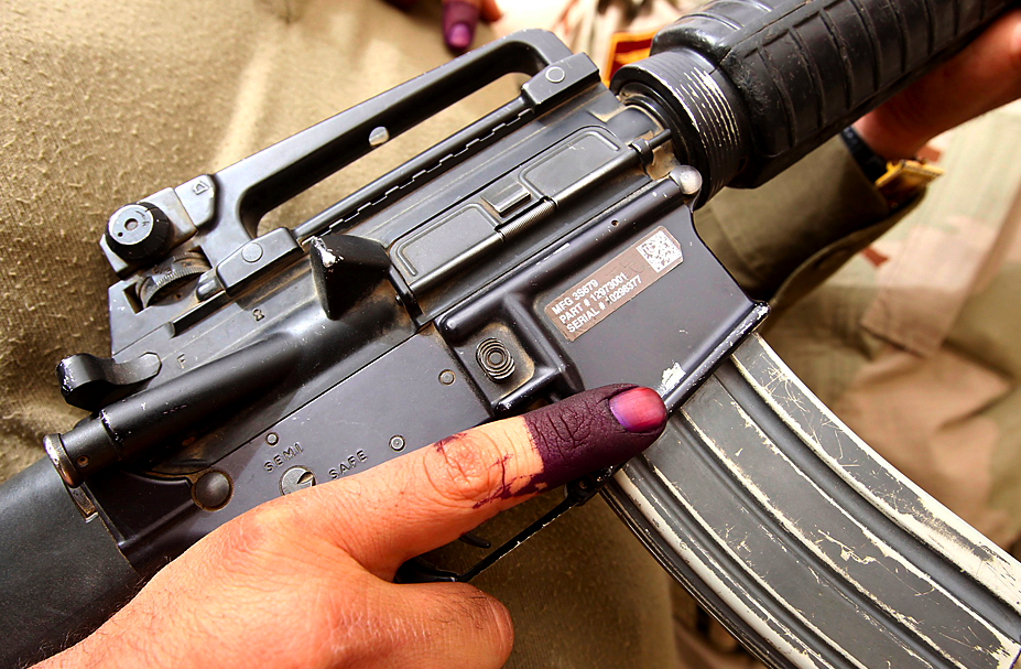 Iraqi security inked finger, gun