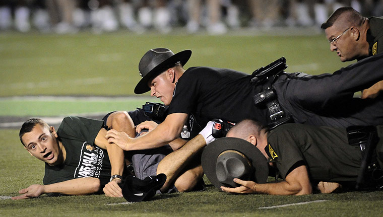 cops on football field takedown