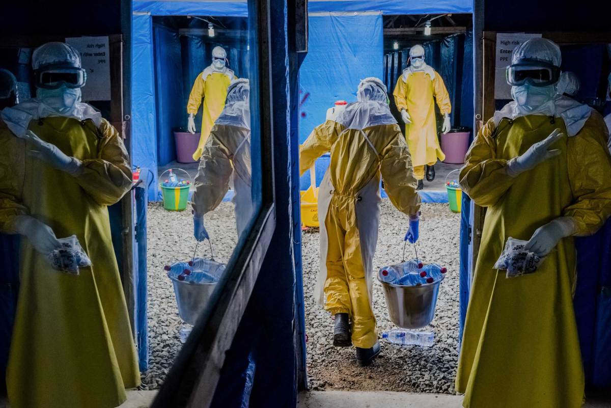 Health workers enter the high-risk zone as they make the morning rounds at the Bong County Ebola Treatment Unit, in Sgt. Kollie Town near Gbarnga.