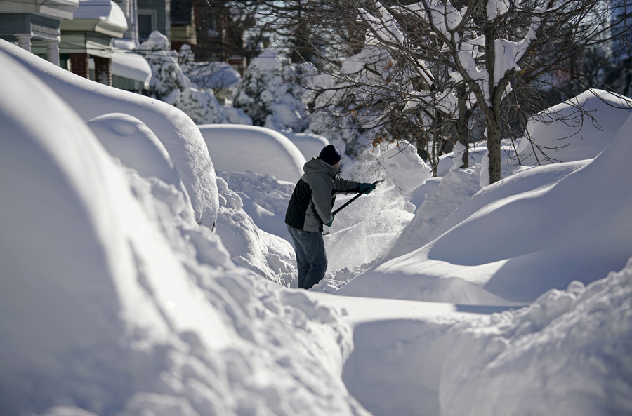 A resident shovels snow away from the entrance to his home in Union City, New Jersey, across the Hudson River from Midtown Manhattan, after the second-biggest winter storm in New York history, January 24, 2016. REUTERS/Rickey Rogers TPX IMAGES OF THE DAY - RTX23SDE